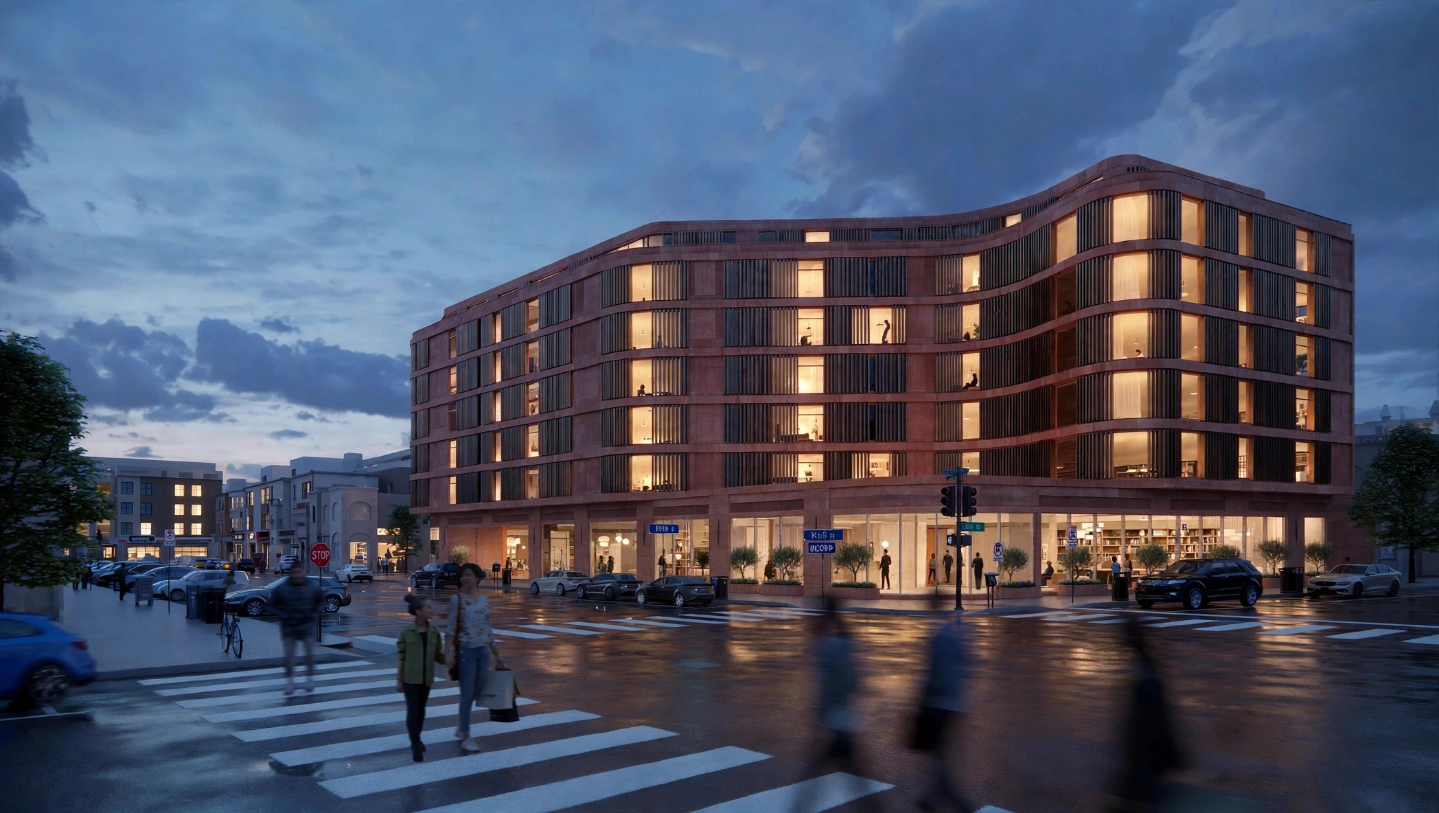 DC Multifamily, a curved brick residential building on a city street at dusk